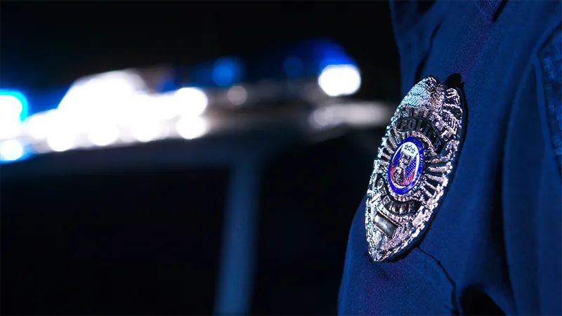 Police badge on arm